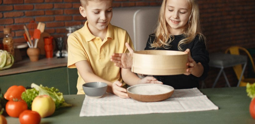 Some kids trying to bake.