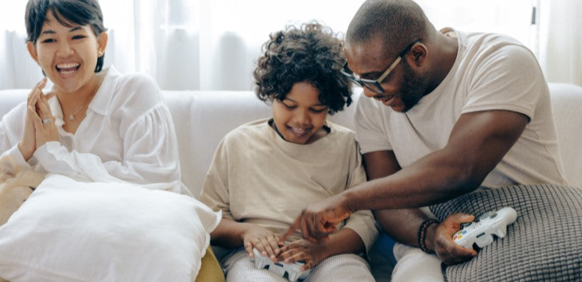 A family are happily playing a video game.