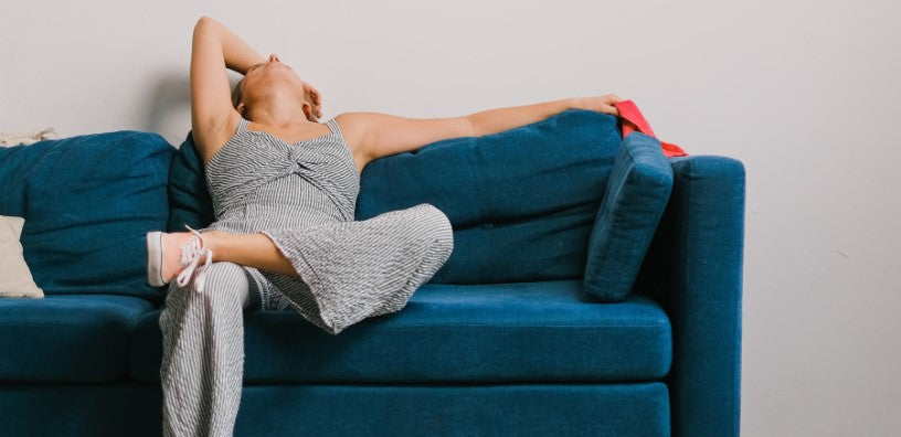 A woman is relaxing on her couch.