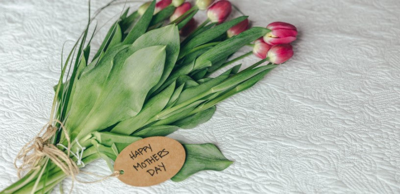 A bouquet of flowers with a tag saying "Happy Mother's Day."