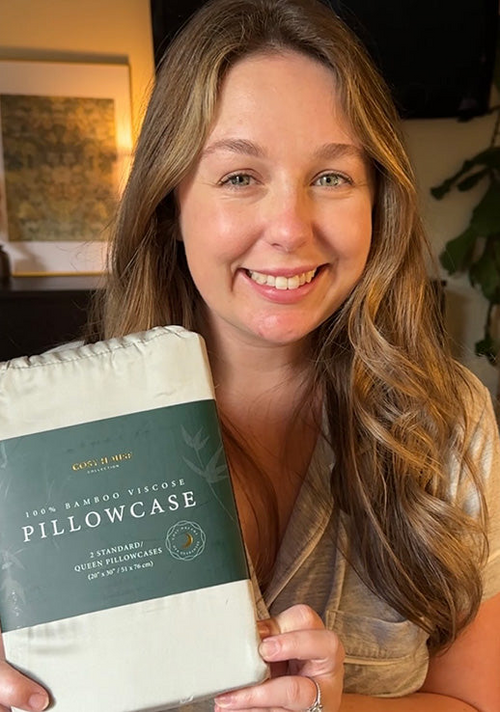 A satisfied customer holding a packaged pair of 100% Bamboo pillowcases.