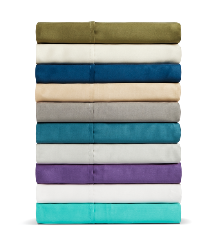 A stack of Cosy House Collection sheets in various colors.