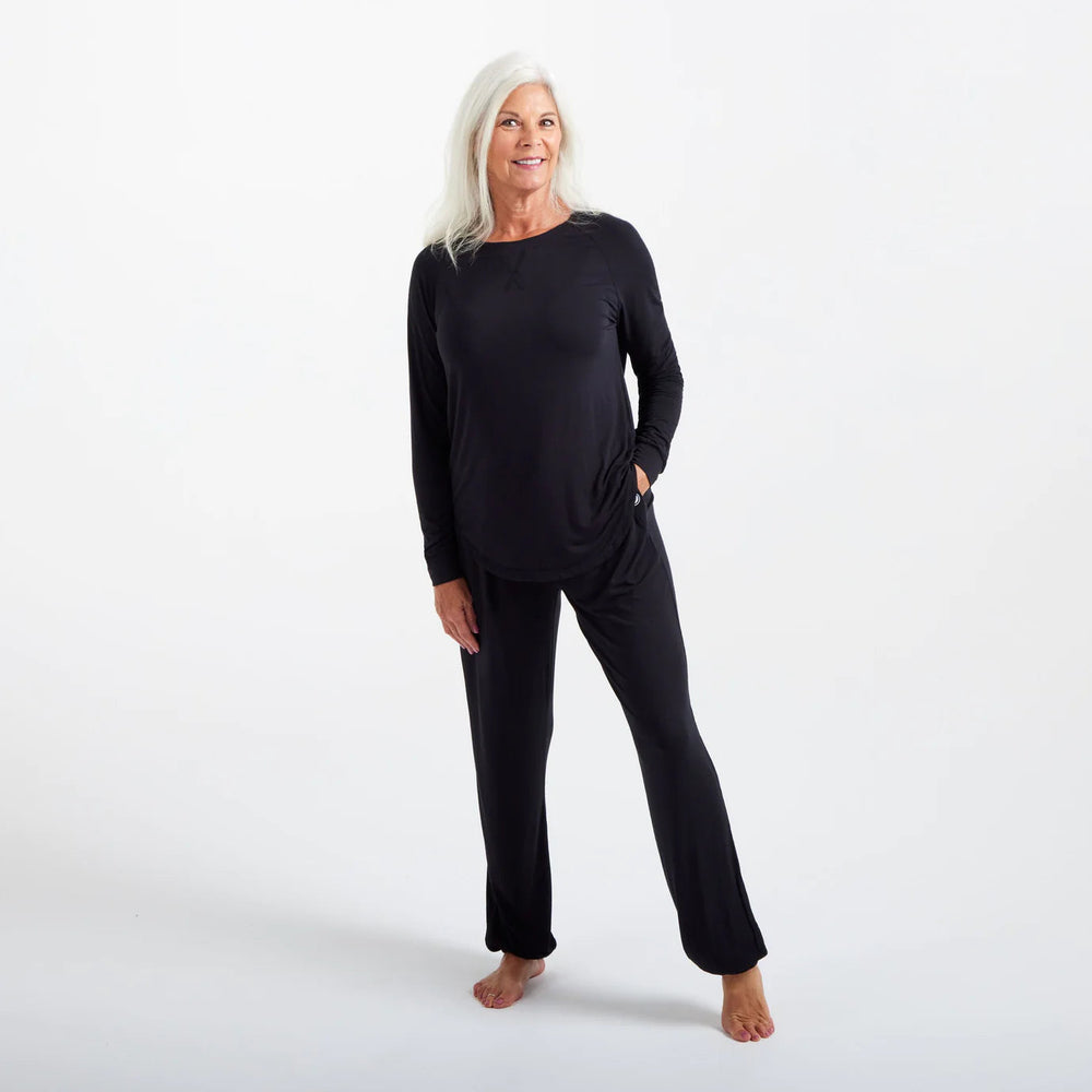 Another view of a woman using her Cosy House Collection Bamboo Loungewear.