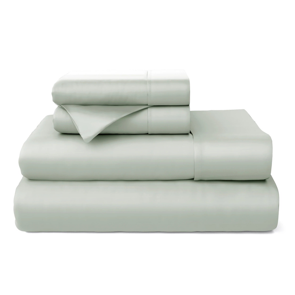 Cosy House Collection sheets and pillowcases stacked together, highlighting their fresh and tranquil appearance.