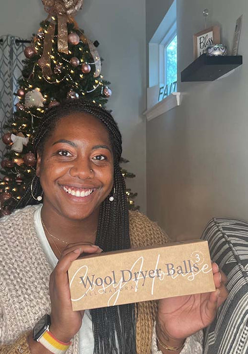 A happy customer showing her packaged Cosy House Collection All Natural Wool Dryer Balls.