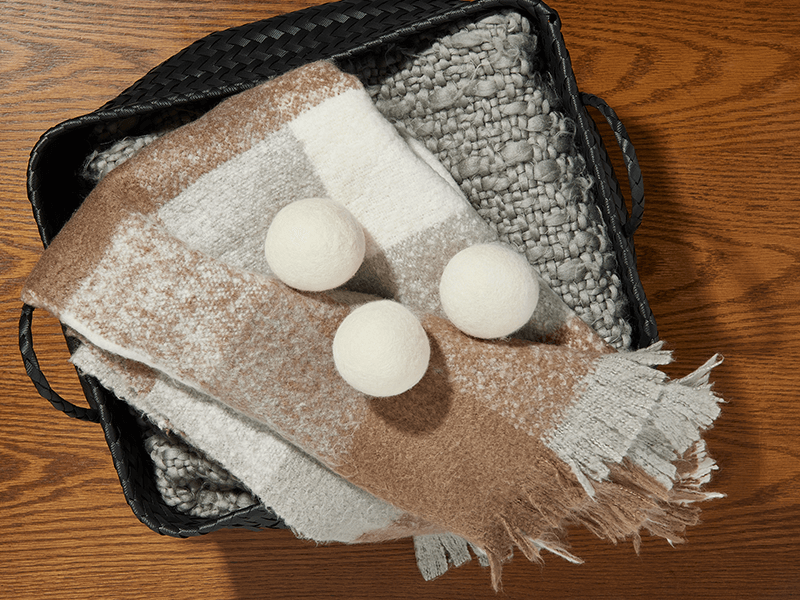 All Natural Wool Dryer Balls on top of some garments.